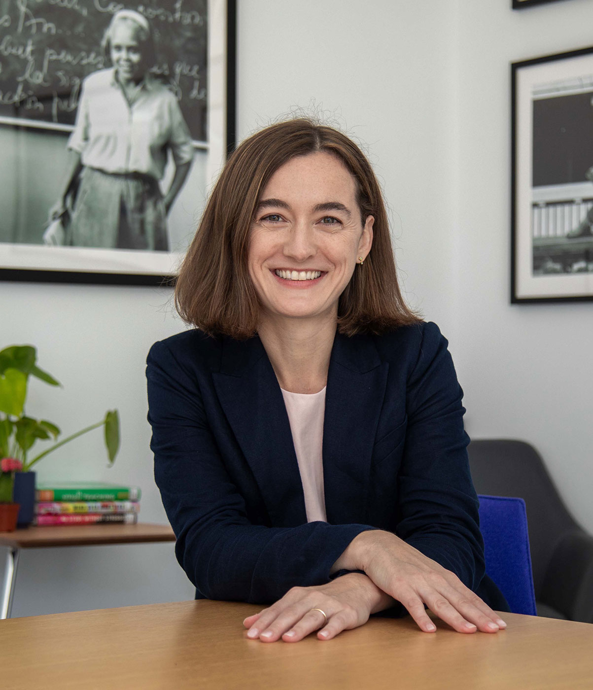 Woman wearing dark suit jacket sitting at desk