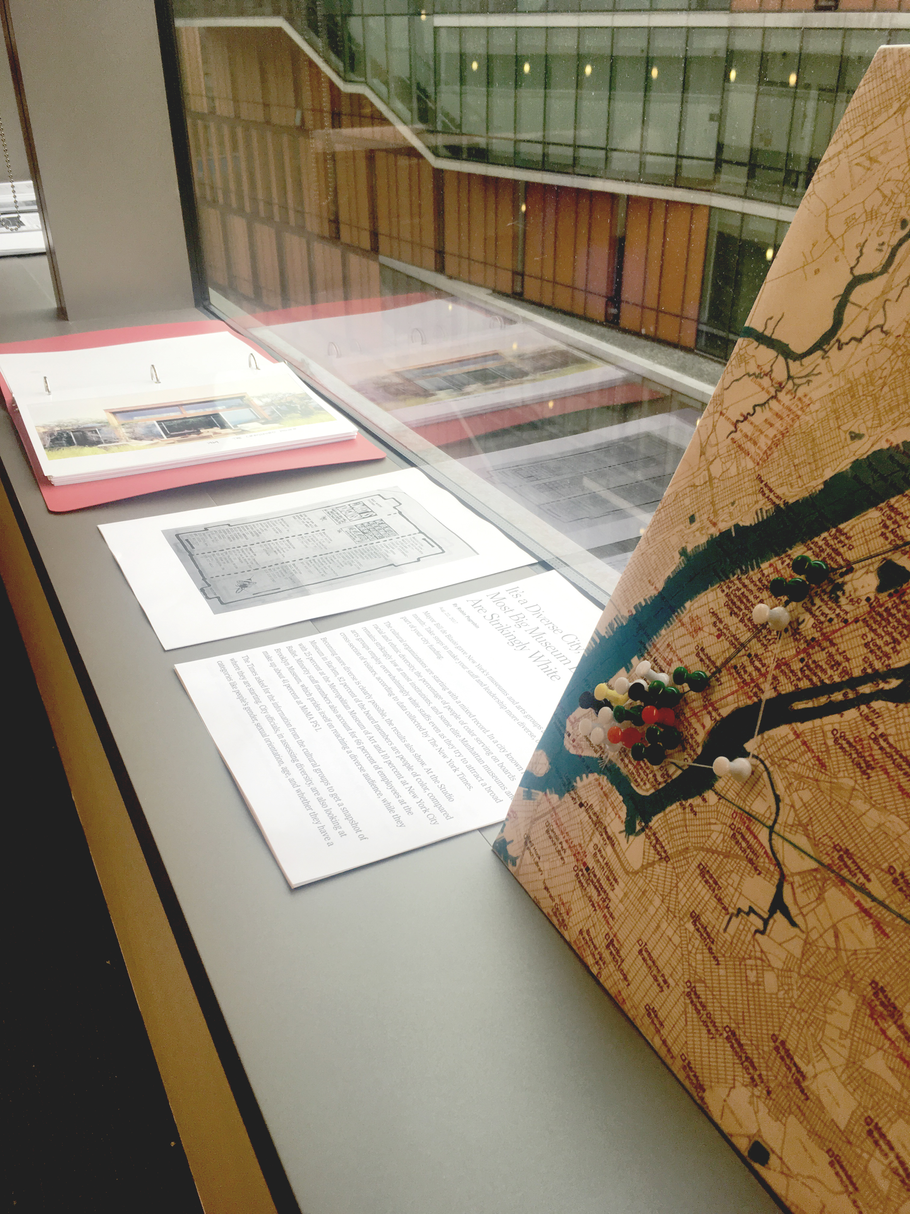 Materials from Professor Siddiqi's class are laid out on a window sill, available for the exhibit's visitors to peruse.