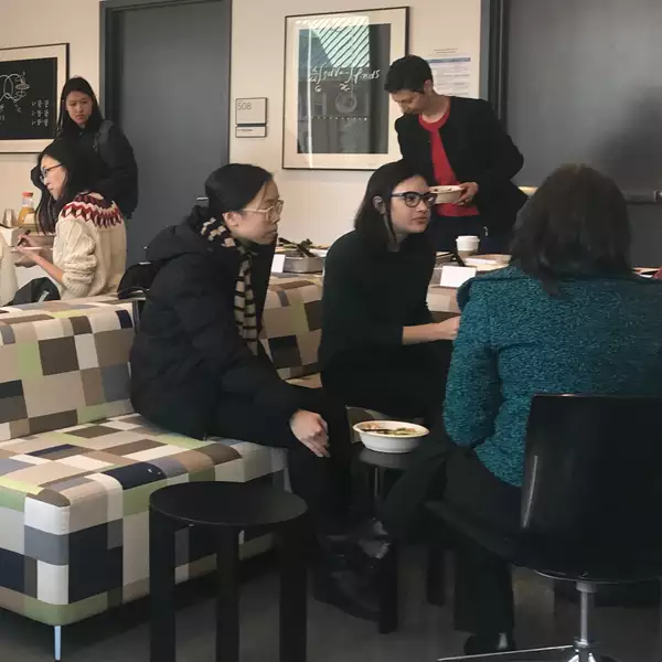 Young women gather in a social space for lunch