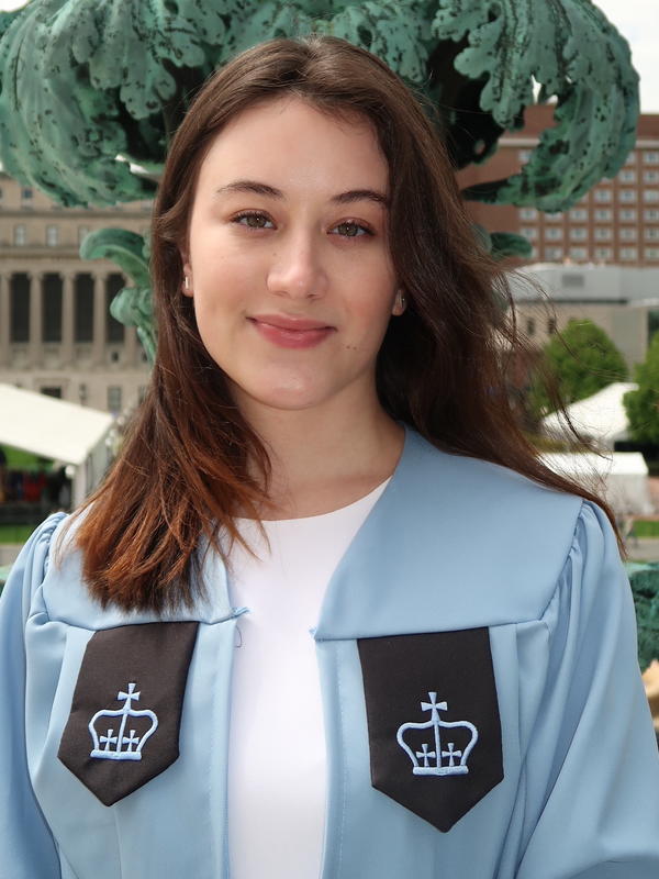 Woman with brown hair and a pastel blue graduation gown